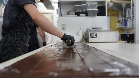 Phillips chocolate worker hands rolling out fresh chocolate