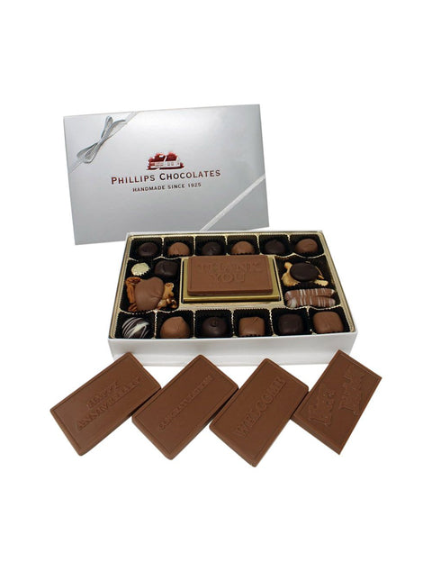 Celebrate The Occasion Box featuring an assortment of handmade milk chocolate plaques perfect for gifting on any special day.