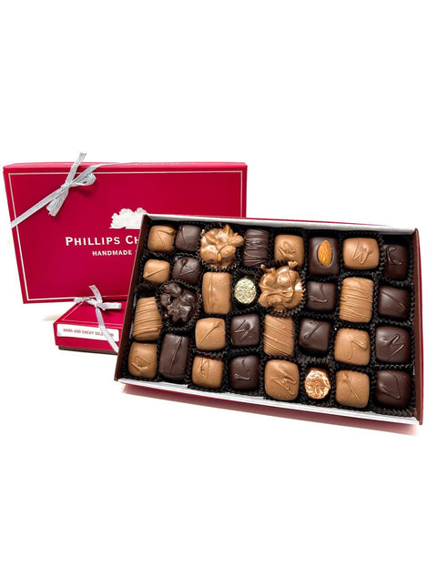 1lb Hard and Chewy Assortment by Phillips Chocolate, elegantly displayed in a luxurious red box featuring an assortment of rich chocolates, including dark and milk varieties, beautifully arranged for ultimate indulgence.