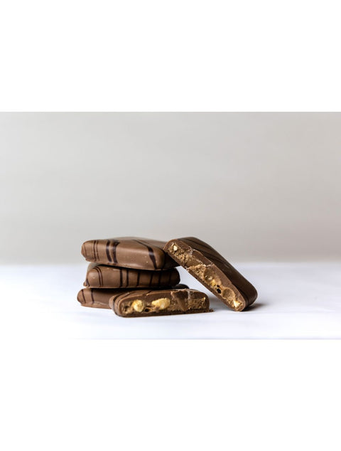 Delicious PEANUT BUTTER BARK featuring milk chocolate with drizzled dark chocolate, showcasing a crunchy chocolate peanut butter filling from Phillips Chocolate.