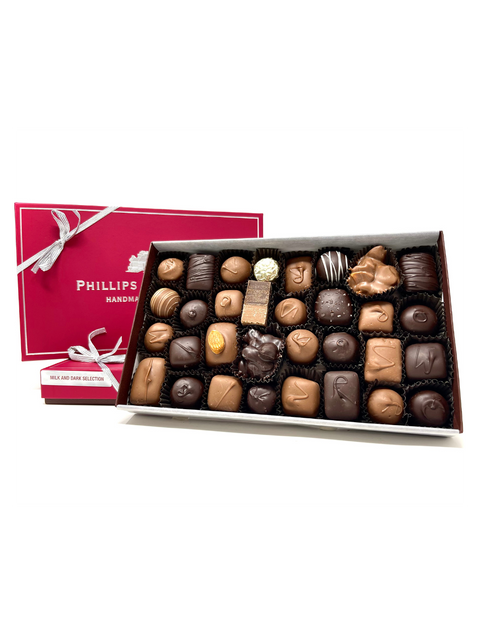 1 LB Milk and Dark Assortment featuring an elegant box filled with an assorted selection of chocolates including creams, caramels, jellies, and nuts, wrapped in both milk and dark chocolate.